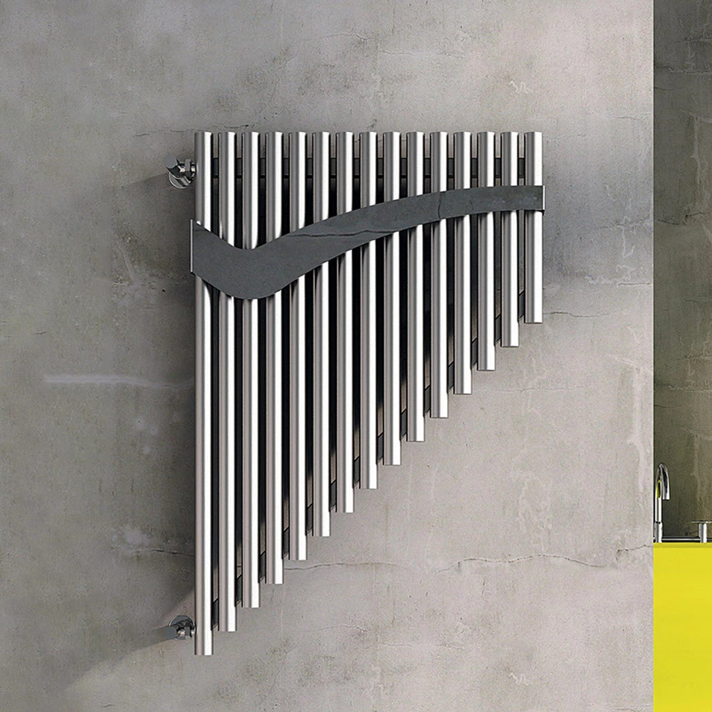 Carisa Pan Designer Stainless Steel Radiator fixed to a concrete wall, in a living space
