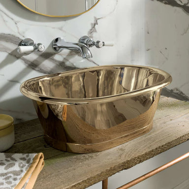BC Designs Brass Roll Top Bathroom Wash Basin 530mm x 345mm on a wooden bathroom vanity unit