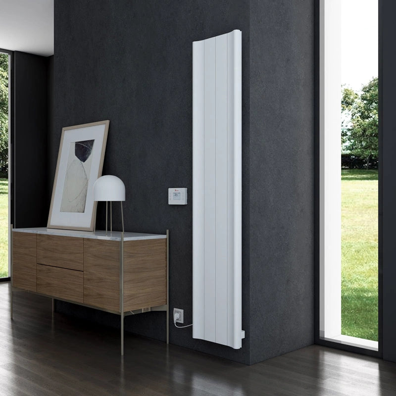 Carisa Boreas B Aluminium Electric Radiator, fixed to a grey wall in a living space next to a window