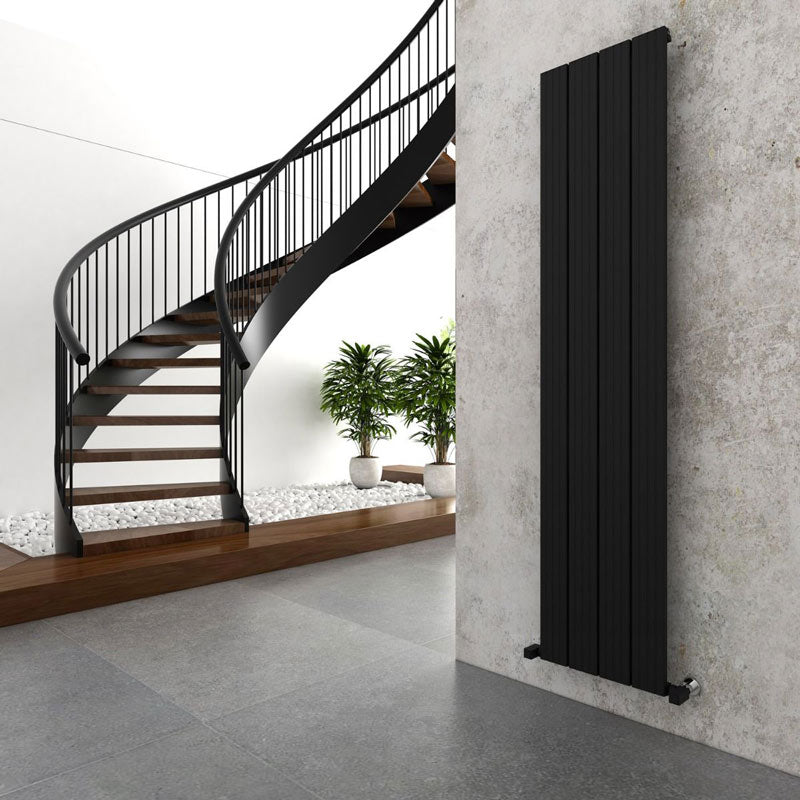Carisa Chambord Vertical Aluminium Radiator, in a living space next to a swirl staircase
