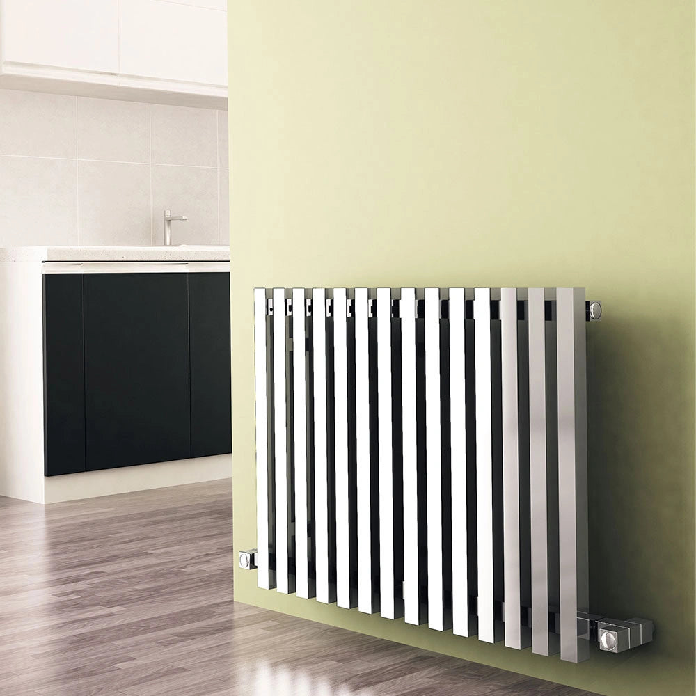 Carisa Zara Horizontal Designer Radiator, fixed to a light green wall in a living space