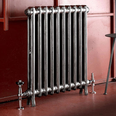 Arroll Edwardian 2 Column Cast Iron Radiator fixed next to a red painted wall