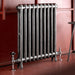 Arroll Edwardian 2 Column Cast Iron Radiator fixed next to a red painted wall