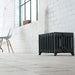 Arroll Victorian 9 Column Cast Iron Radiator, fixed next to a white painted wall