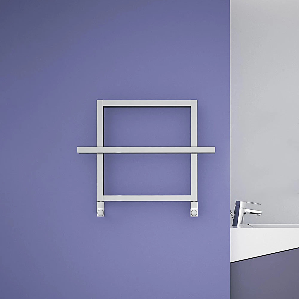 Carisa Ajax I Aluminium Towel Radiator fixed to a lilac painted wall, in a bathroom space