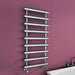Carisa Aldo Towel Radiator fixed to a burgundy painted wall, in a bathroom space