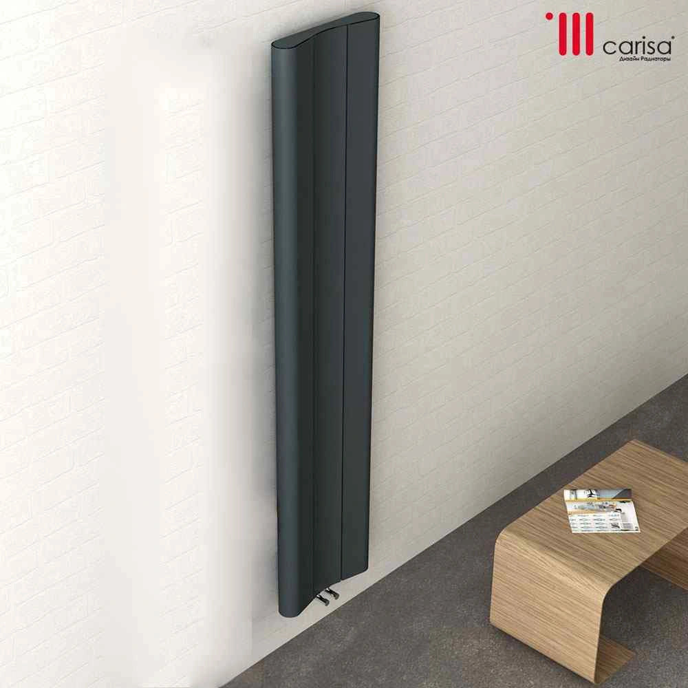 Carisa Curvy Vertical Aluminium Radiator, fixed to a white wall in a living space
