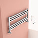 Carisa Fame Horizontal Aluminium Towel Radiator, fixed to a peach painted wall in a bathroom space