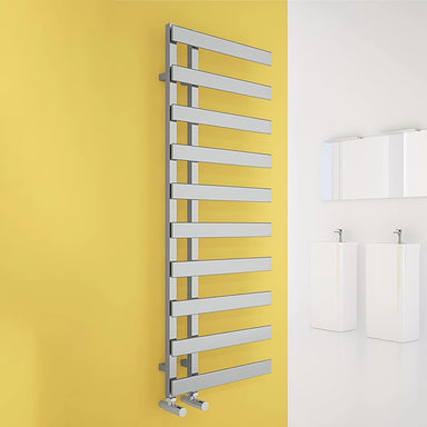 Carisa Floris Heated Towel Radiator, fixed to a yellow painted wall in a bathroom space