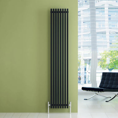 Carisa Sophia Aluminium Vertical Radiator fixed to a lime green wall, in a office space