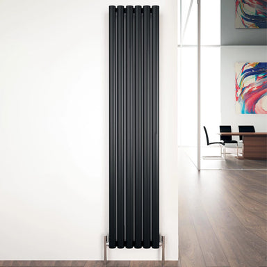 Carisa Tallis Vertical Aluminium Radiator fixed to a white wall in a office or living space