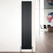 Carisa Tallis Vertical Aluminium Radiator fixed to a white wall in a office or living space