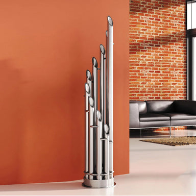 Carisa Unique Stainless Steel Designer Radiator, in a living space next to an orange painted wall