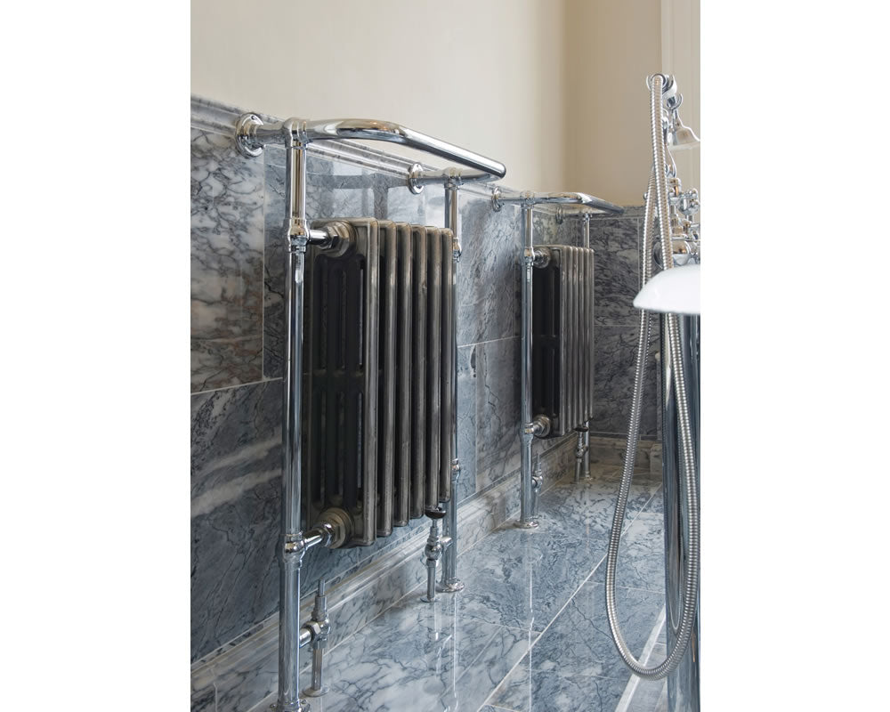 two Carron Broughton Cast Iron Towel Radiators side by side within a bathroom lifestyle image