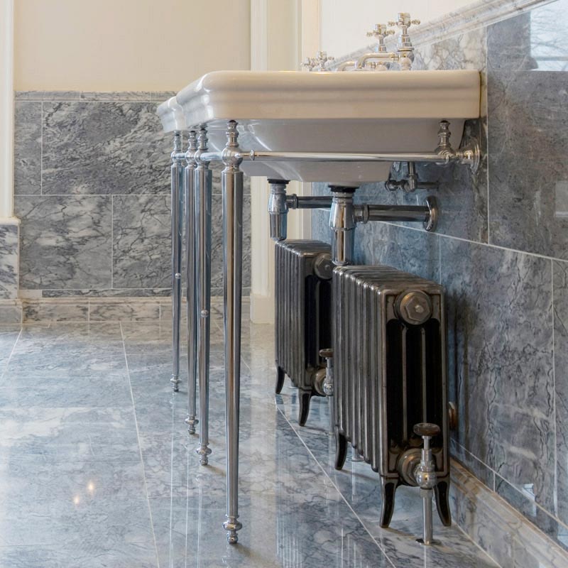 Carron Victorian 4 Column Cast Iron Radiator Special Finish of Hand Burnished 325mm Height Radiator in a bathroom underneath a traditional basin washstand unit