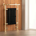 arroll heated towel radiator in black with brushed brass rails vintage influence in bathroom space