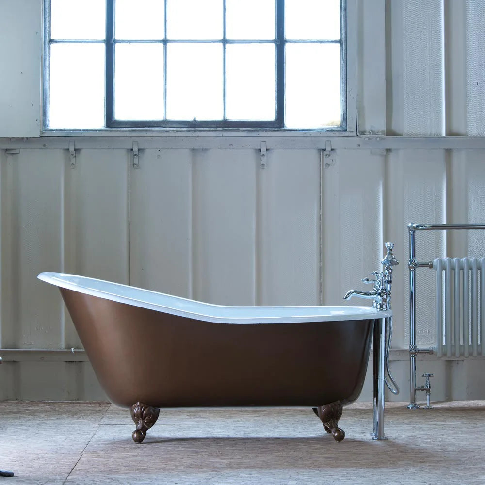 Brown cast iron slipper bath in the middle of a room with brown clawfeet and a silver and white radiator