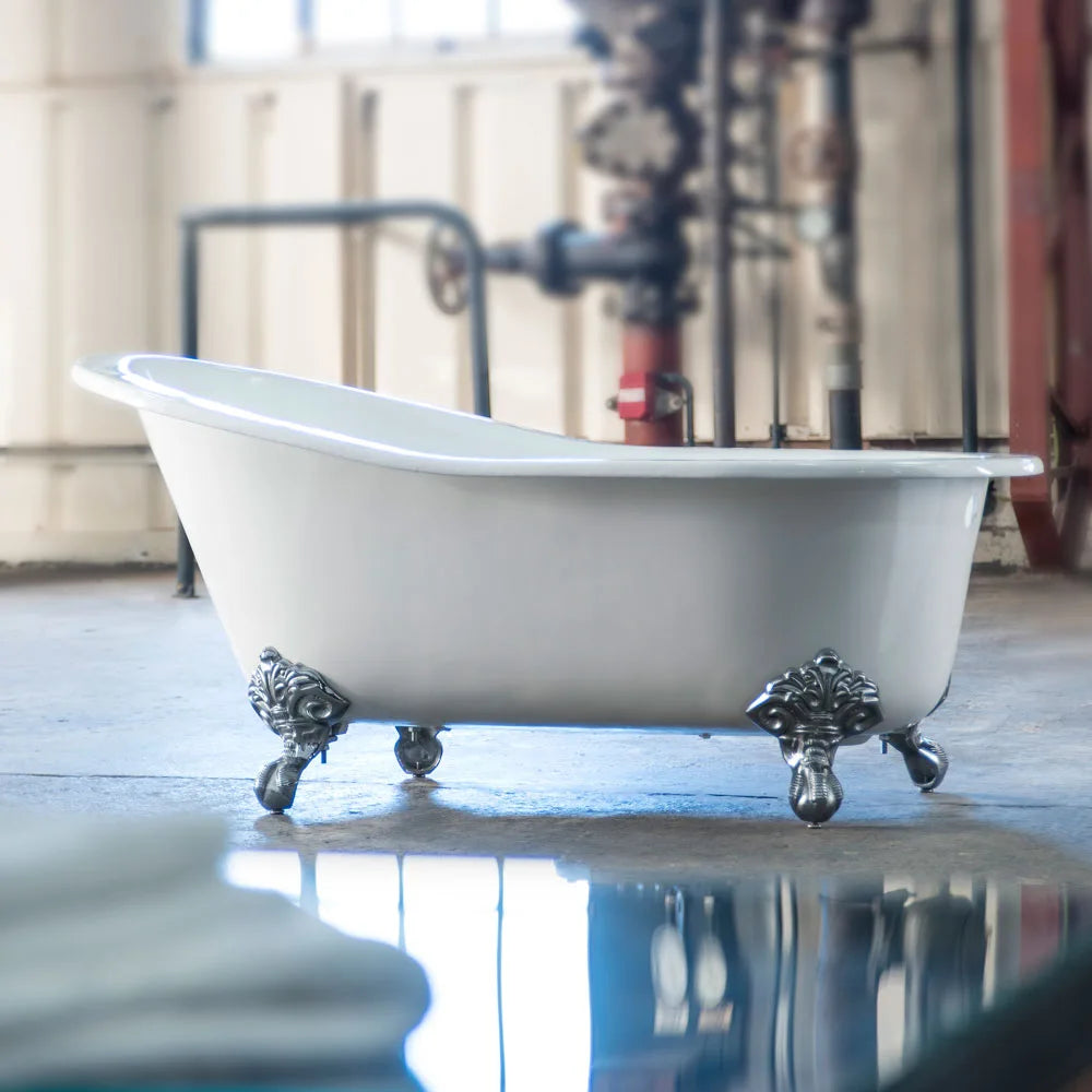 White boat tradiation roll top cast iron bath with polished chrome claw feet in the middle of a room 