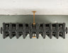 top shot of Arroll brass wall stay bracket fixed to a radiator birds eye view