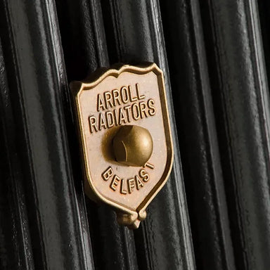 Arroll Luxury Radiator Wall Stay close up shot on black radiator with brass finish