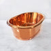 BC Designs Copper Roll Top Bathroom Wash Basin 530mm x 345mm polished copper interior and exterior on a marble vanity unit