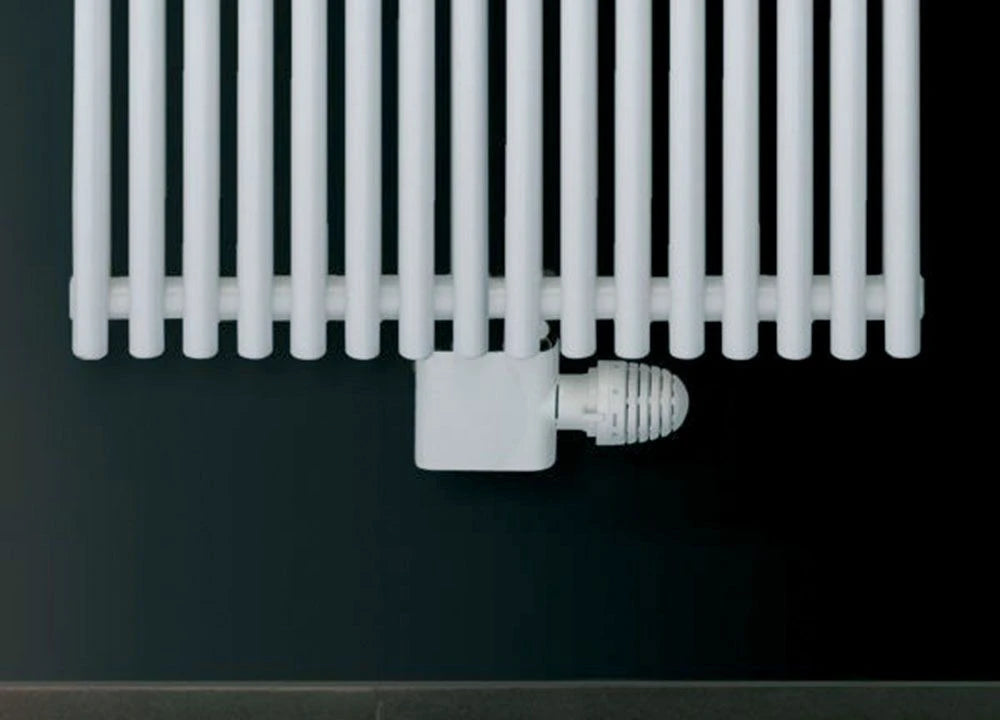Eucotherm Angled Central Radiator Valve white shown on radiator