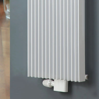 Eucotherm Angled Central Radiator Valve white shown on radiator
